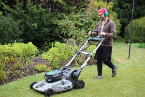 Kyle mowing with an electric mower